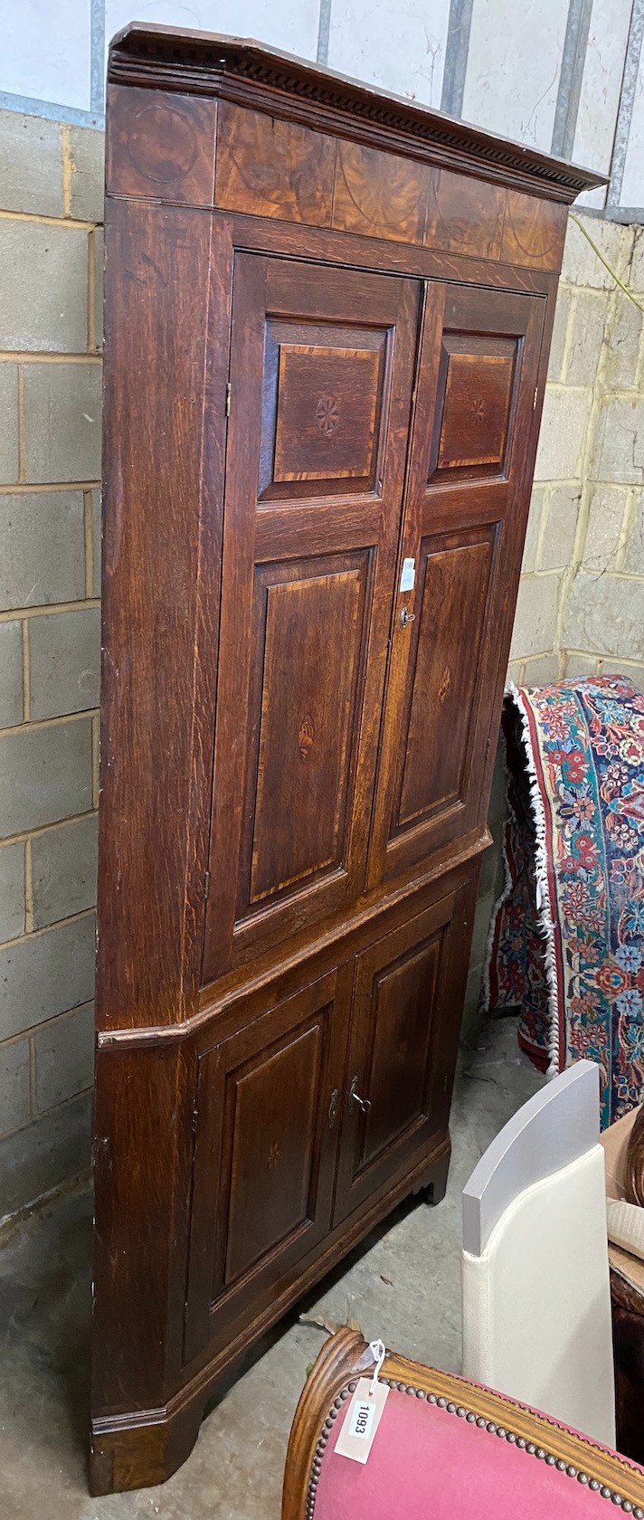 A George III mahogany banded oak standing corner cabinet, width 118cm, depth 64cm, height 224cm
